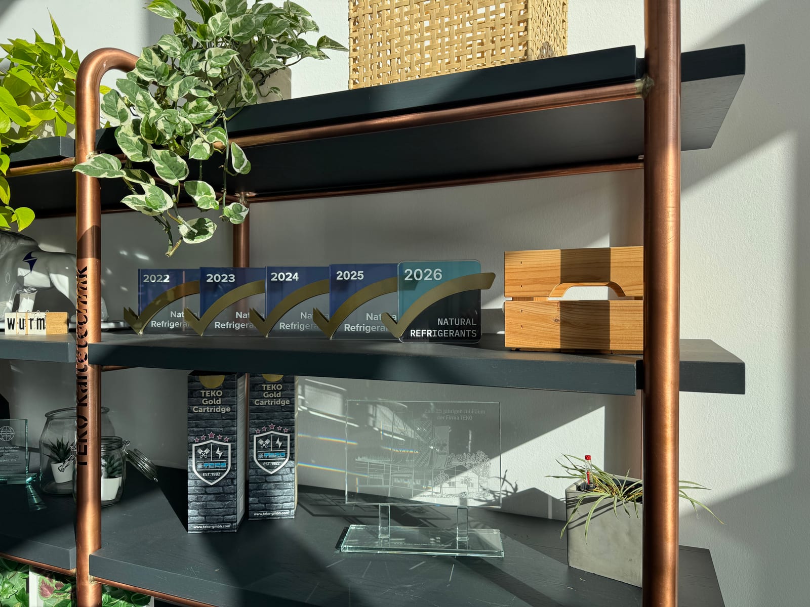 TEKO office shelf with ATMO Approved awards from 2022 to 2026